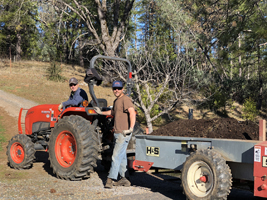 A couple of fellows hauling soil.